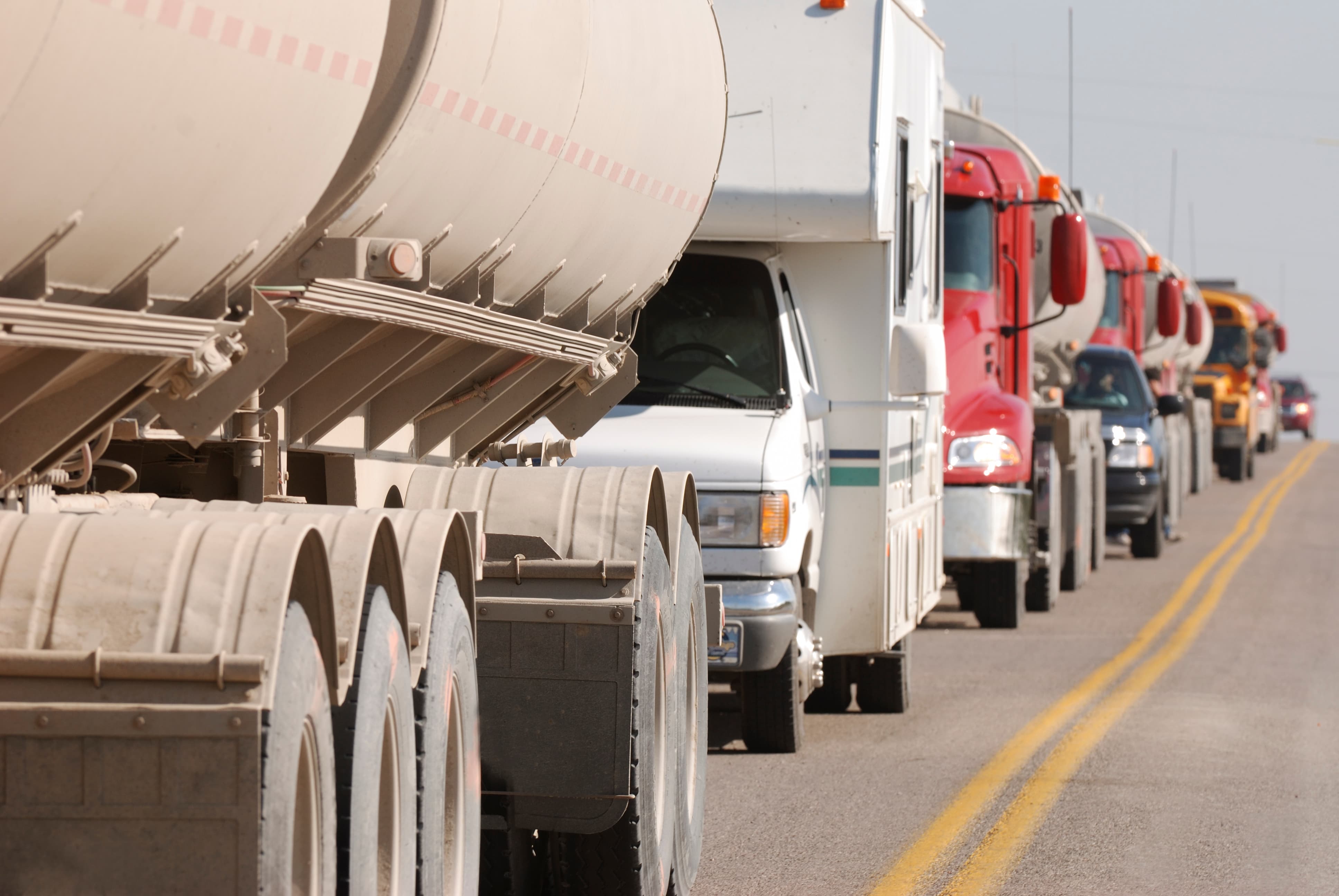 A row of trucks on a crowded road