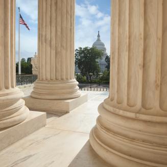 U.S. Capitol building as seen through columns.