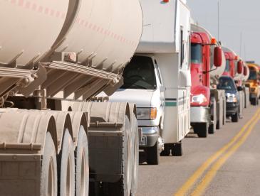 A row of trucks on a crowded road